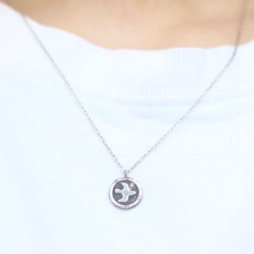Bird Carrying a Diamond Coin Necklace